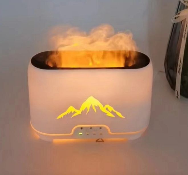 Aromatherapy diffuser with mountain design on a white surface