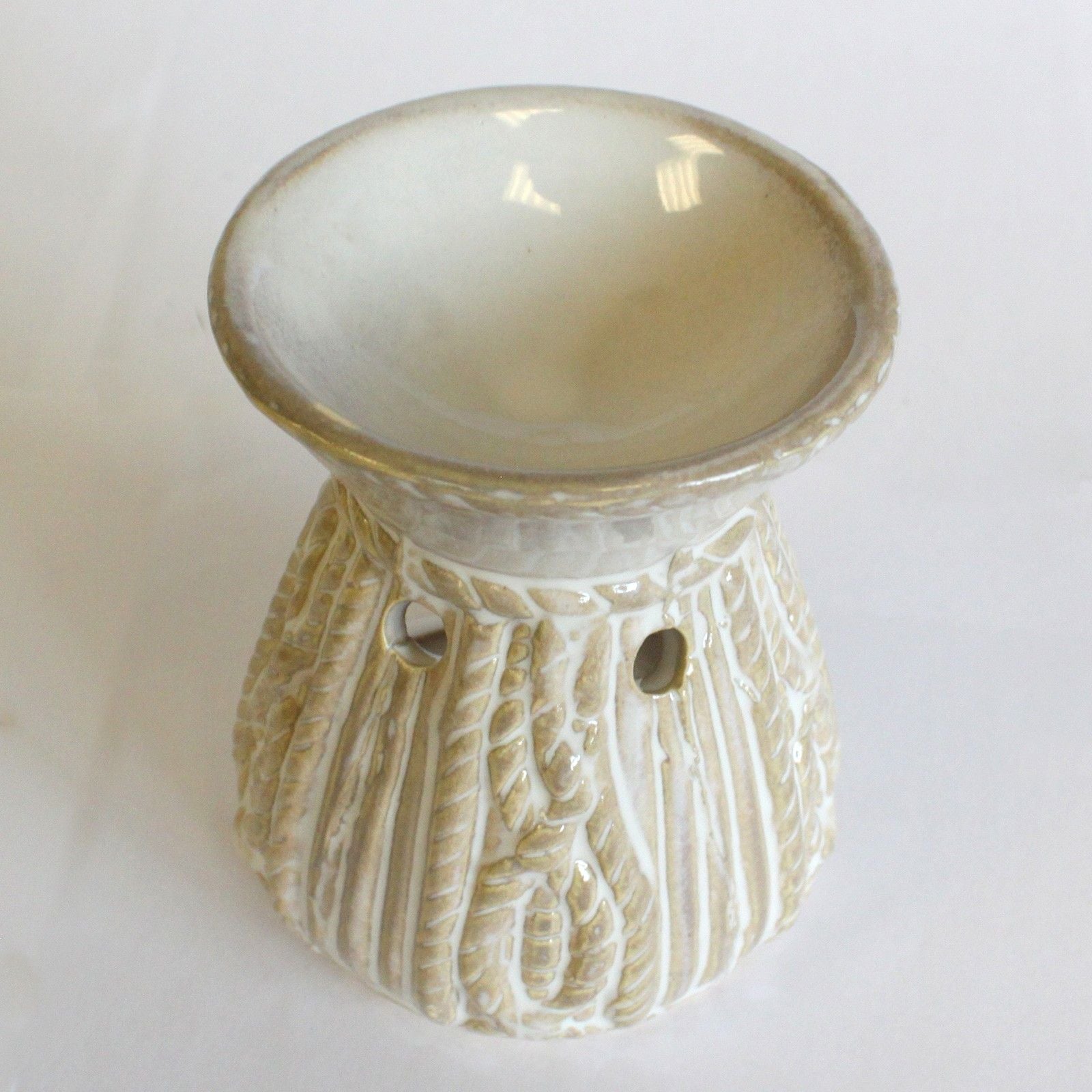 Ceramic oil burner with a rope textured design on a white background