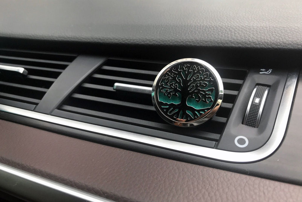 Car air freshener with tree design on a car vent