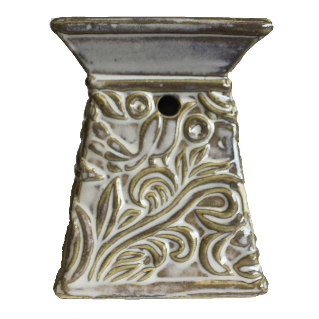 Decorative ceramic oil warmer with intricate patterns on a white background