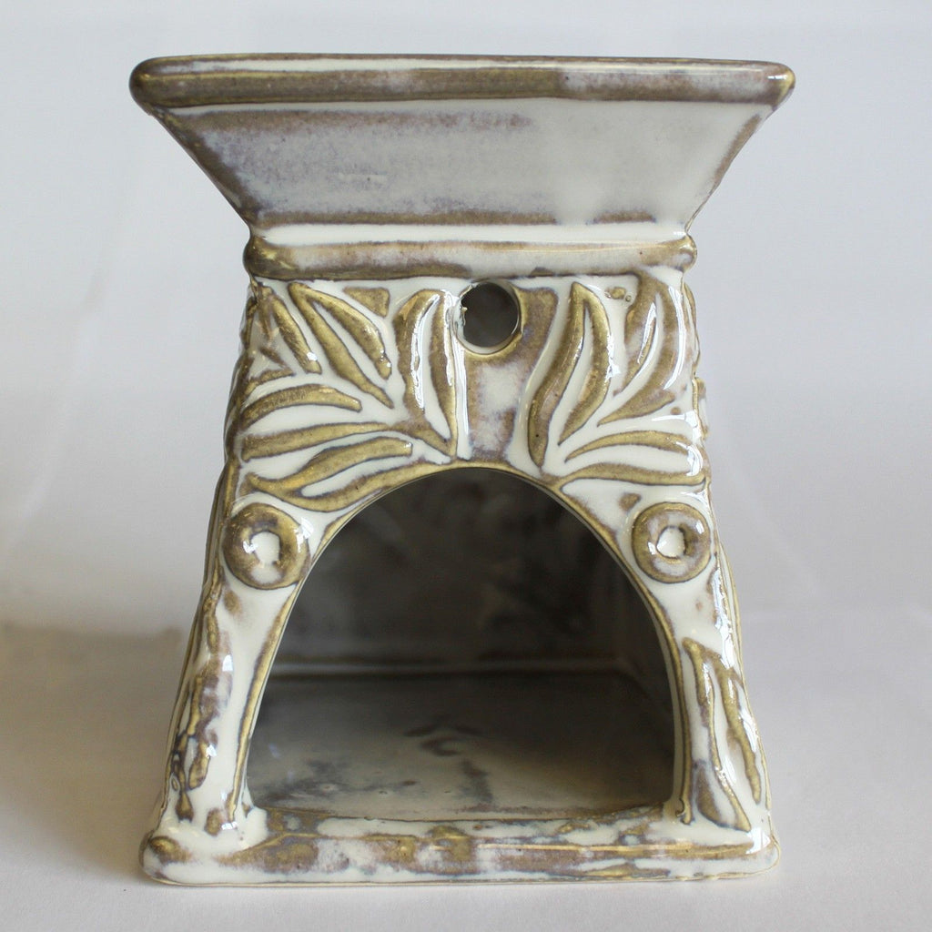 Ceramic oil burner with decorative patterns on a white background