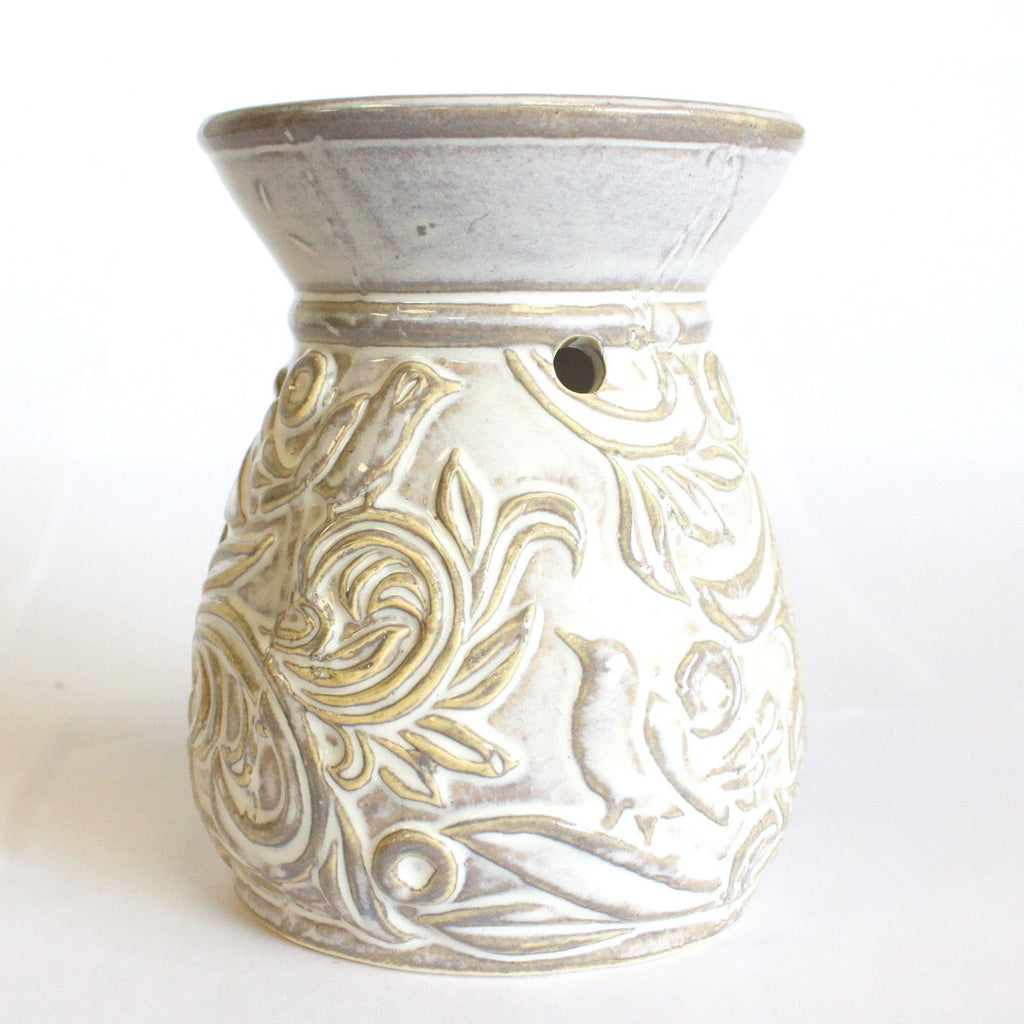 Decorative ceramic oil burner with floral patterns on a white background