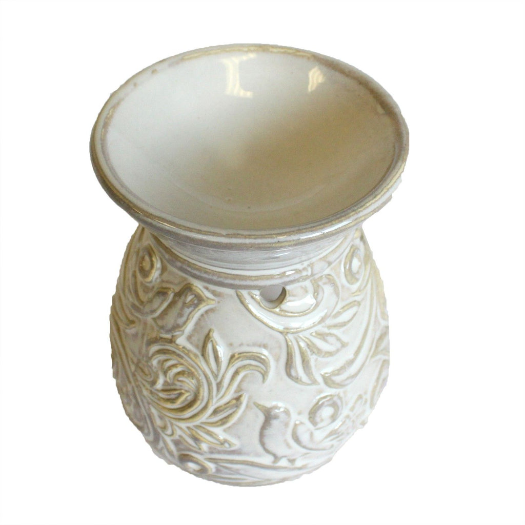 Decorative ceramic oil burner with embossed design on a white background