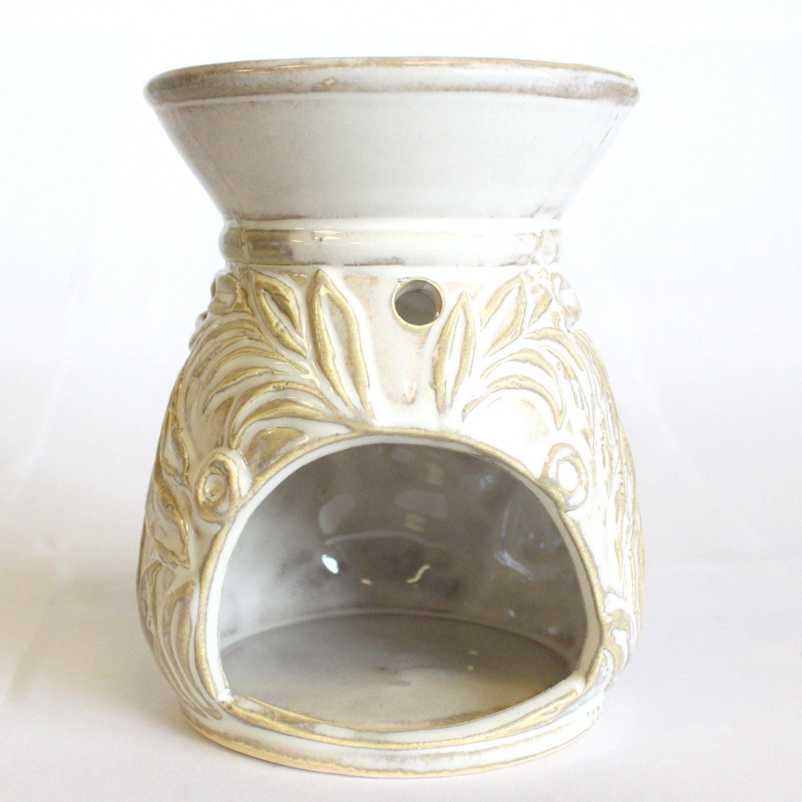 Decorative wax warmer with gold leaf patterns on a white background