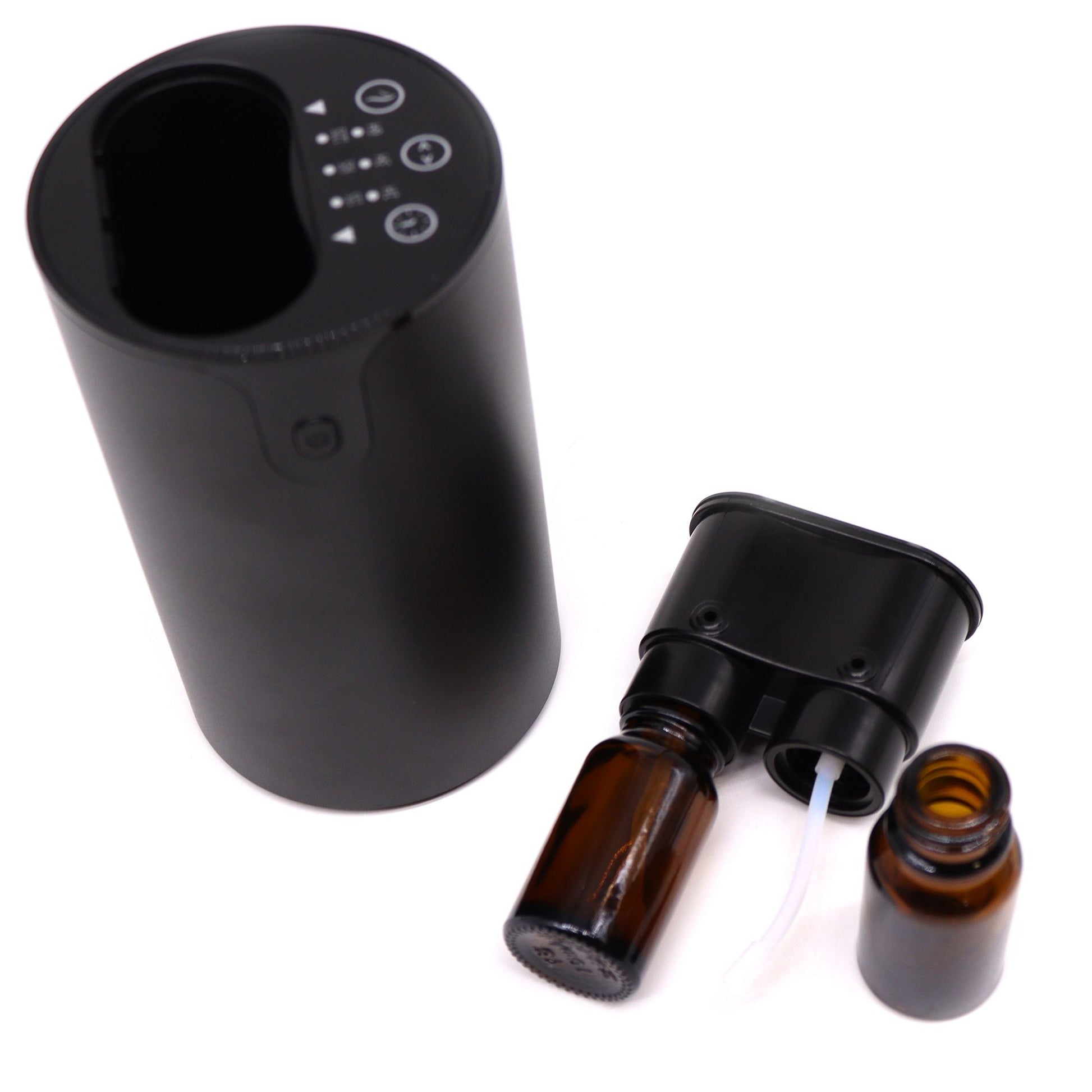 Black electronic device with brown glass bottles on a white background