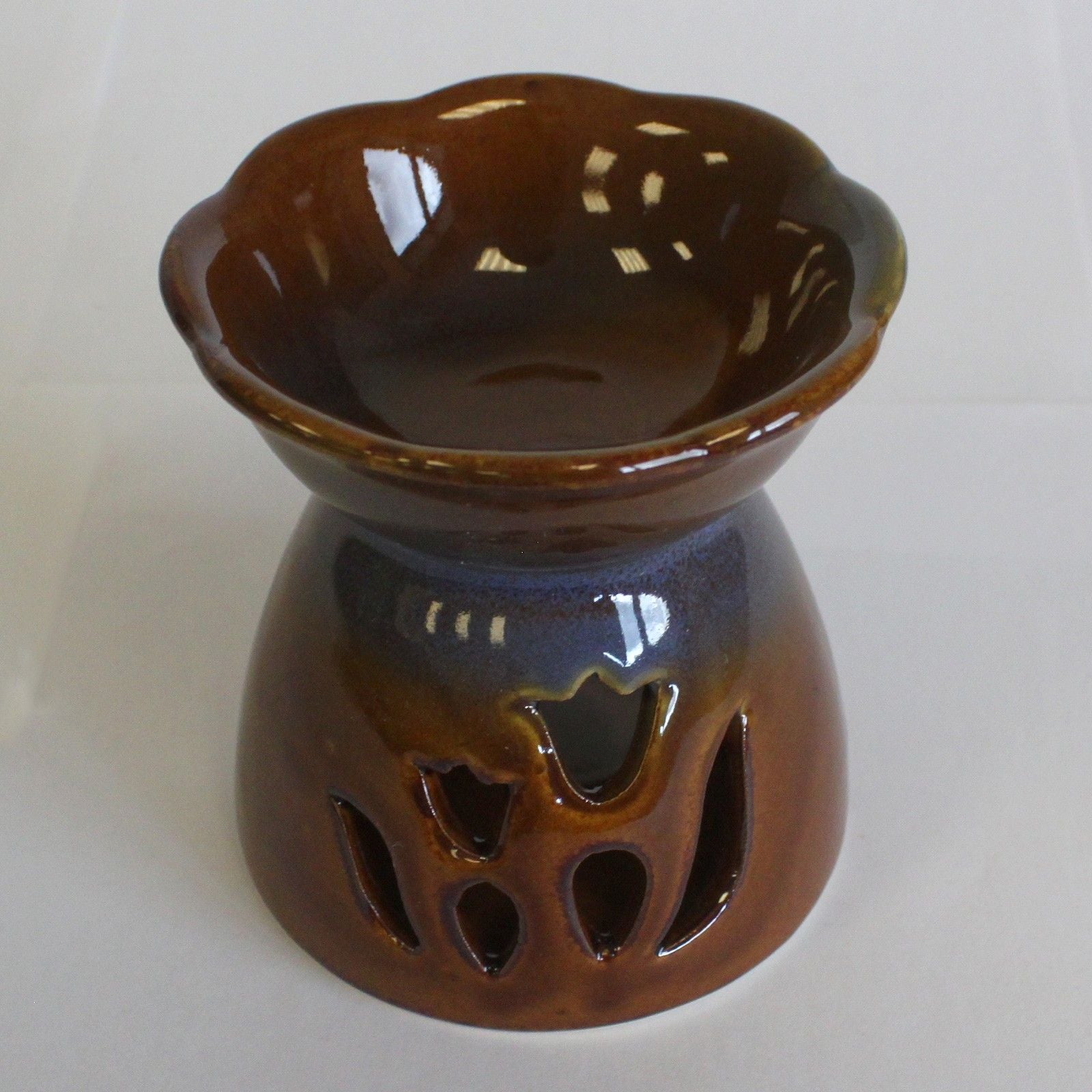 Brown ceramic oil burner with tulip design on a white background