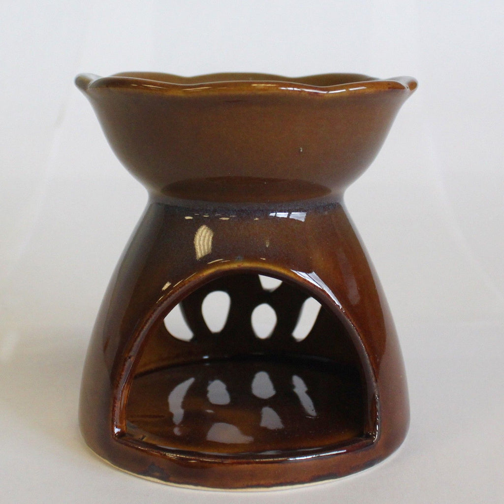Brown ceramic oil burner with tulip cut out design on a white background