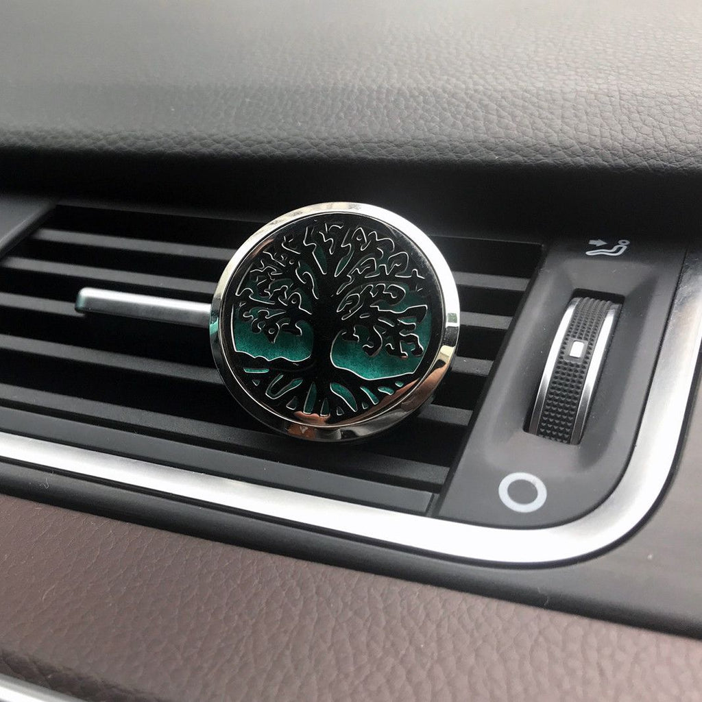 Car air freshener with tree design on a car dashboard