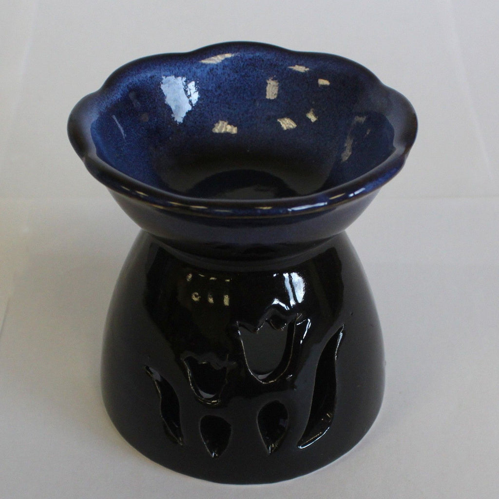 Black ceramic oil burner with blue interior on a white background