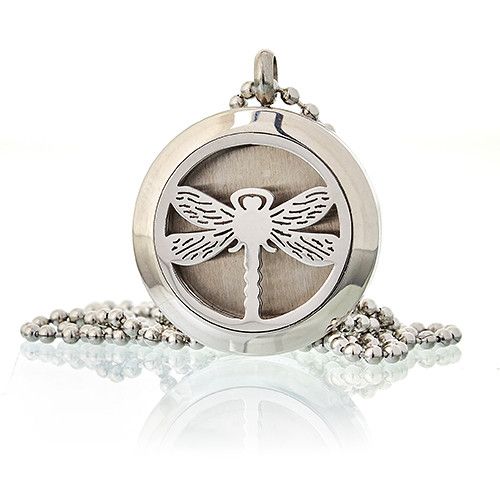 Silver locket with dragonfly design on a white background