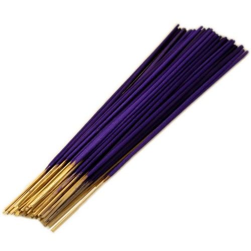 Purple and gold incense sticks on a white background
