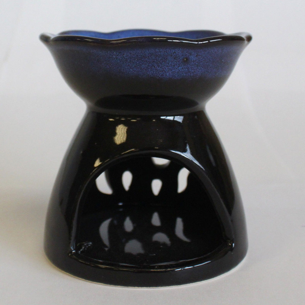 Black ceramic oil burner with blue interior on a white background