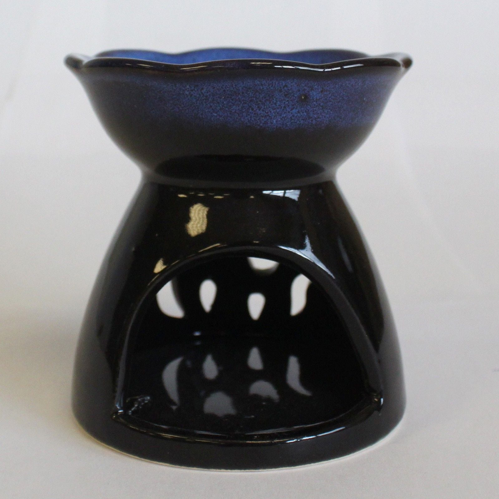 Black ceramic oil burner with blue interior on a white background
