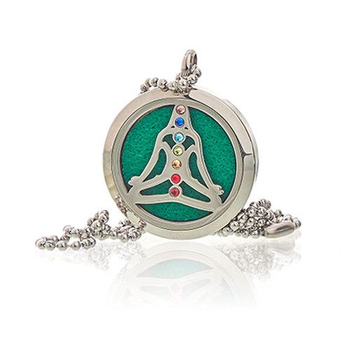 Round pendant with green center and colorful stones on a white background